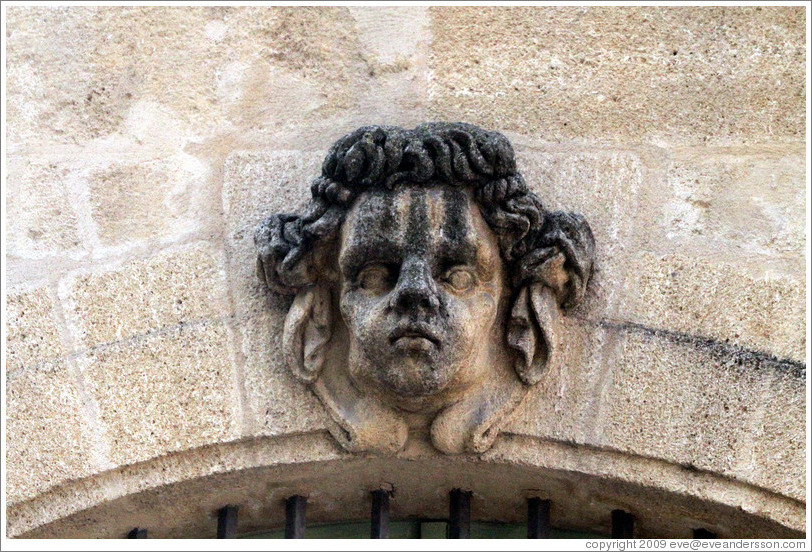 Sculpture of a man's face adorning the facade of the Halle aux Grains (the former Grain Exchange, 1759-61).  Place de l'H? de Ville (city hall plaza).