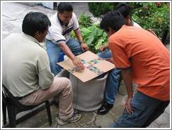 Guys playing a board game (basically: roll the dice and move forward that number of squares).