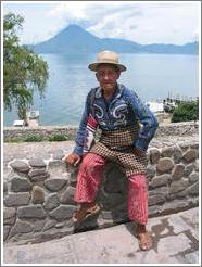 Man in traditional wear in Panajachel, in front of Lago de Atitl&aacute;n.