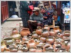 Woman and man selling pots.