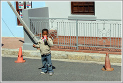 Boy drinking a can of Coke. Chiappini Street, Bo-Kaap.