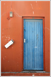 Orange building with blue door. Chiappini Street, Bo-Kaap.