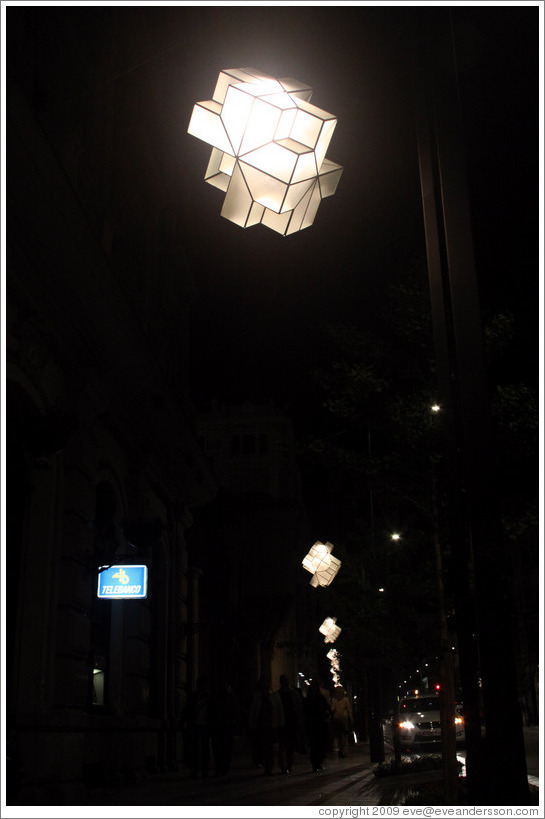 Row of street lights at night.  Calle Gran V?de Col? City center.