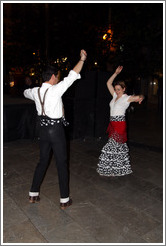 Man and woman dancing flamenco on the street at night during the Fiesta de las Cruces.  Plaza del Carmen.  City center.
