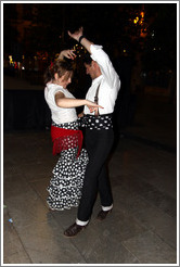 Woman and man dancing flamenco on the street at night during the Fiesta de las Cruces.  Plaza del Carmen.  City center.