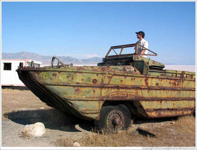 Jesse at helm of old duckboat near Spiral Jetty.