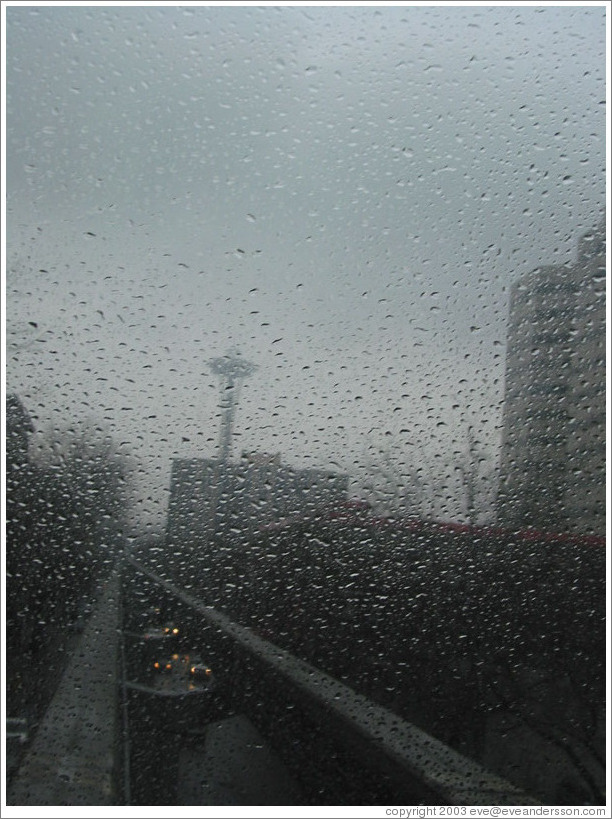 What Seattle really looks like (grey, rainy).  Space needle as seen through the Monorail window.